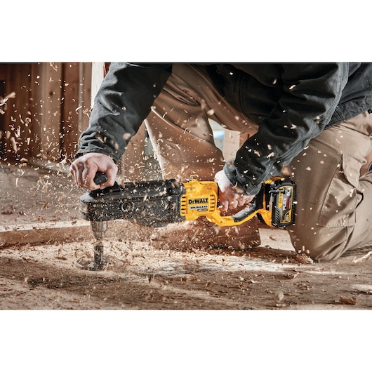 In line stud and joist drill with E-clutch System drilling  floor.
