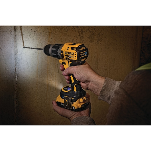 Cordless Compact Hammer Drill with Tool Connect drilling into  wall.
