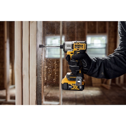 DCF845 20V MAX 1/4 inch 3-Speed Impact Driver drilling a hole into wood