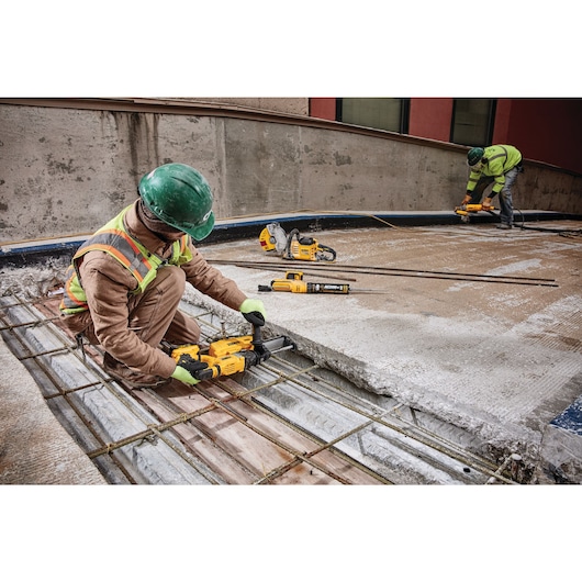 Brushless SDS PLUS D-Handle rotary hammer being used by a person