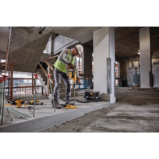 SDS MAX Brushless combination rotary hammer being used by a person