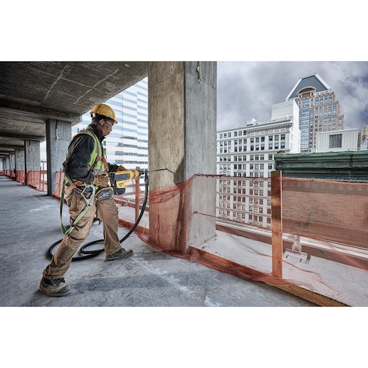 Brushless, cordless SDS MAX combination rotary hammer being used by a person