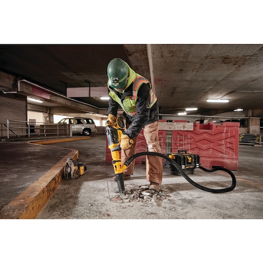 Brushless, cordless SDS MAX combination rotary hammer being used by a person