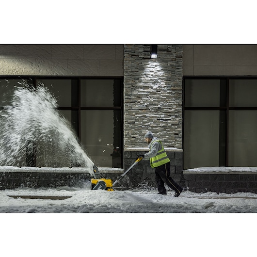 DEWALT Single-Stage Snow Blower application image person blowing snow side view