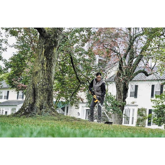 Folding String Trimmer being used by a person.