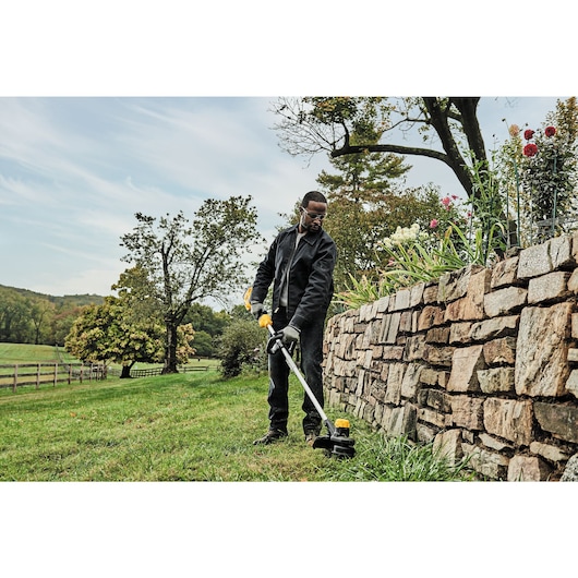 low angle view of Cordless String Trimmer being used.
