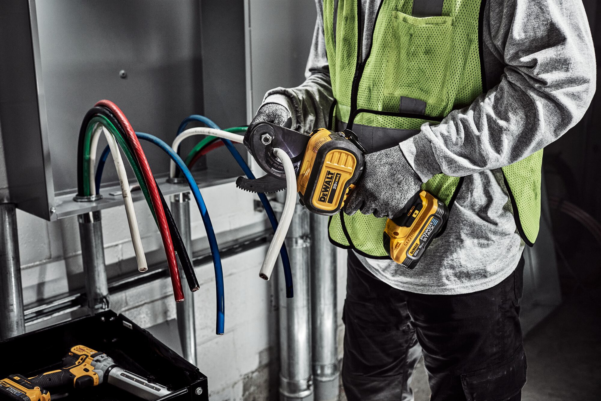 DEWALT Cable Cutter is used to cute cable to length by a tradesman in a electrical room. DEWALT Cable Cutter is used to cute cable to length by a tradesman in a electrical room.