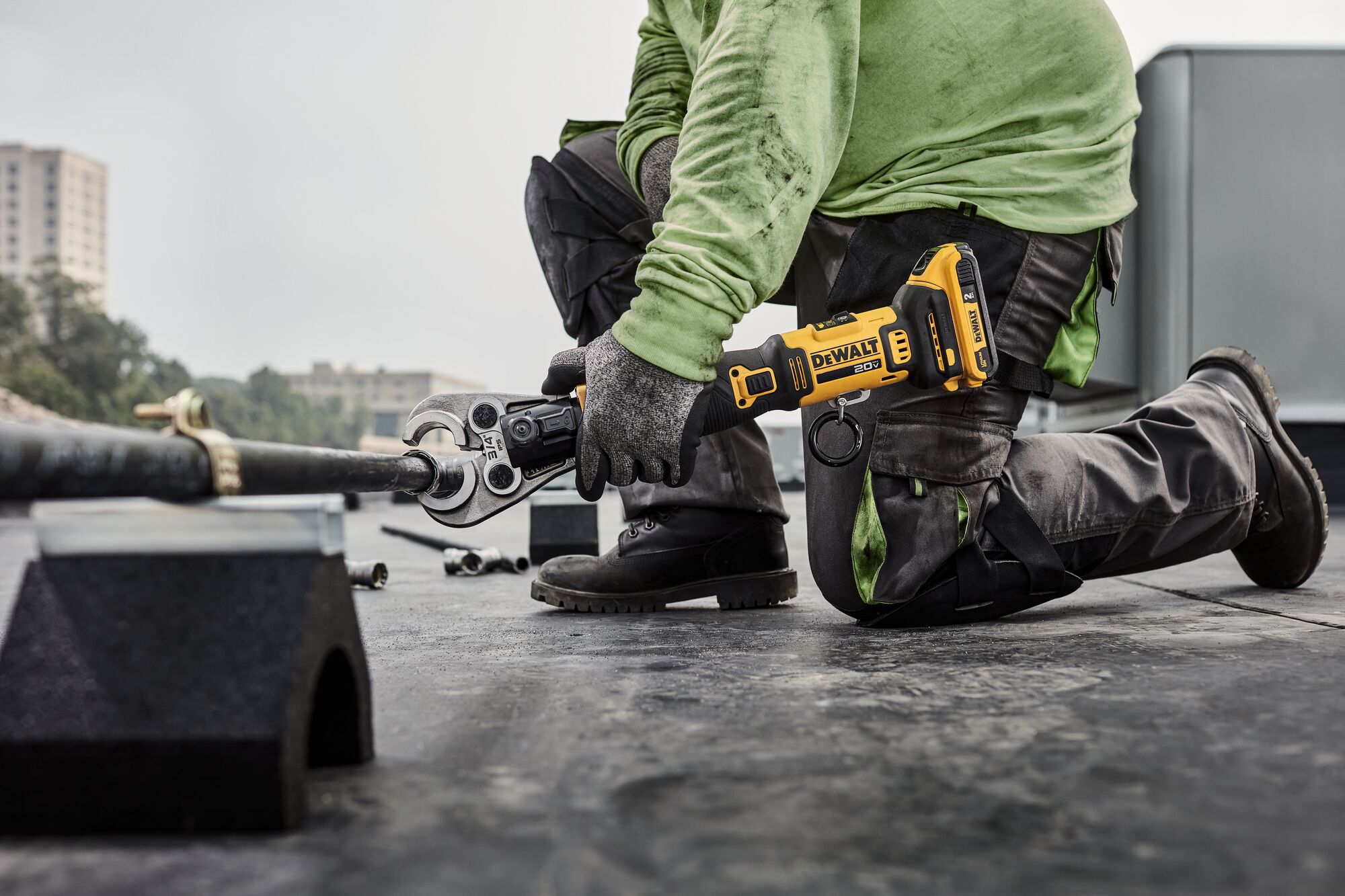 DEWALT Compact Press Tool getting ready to press black iron pipe on a rooftop. DEWALT Compact Press Tool getting ready to press black iron pipe on a rooftop.