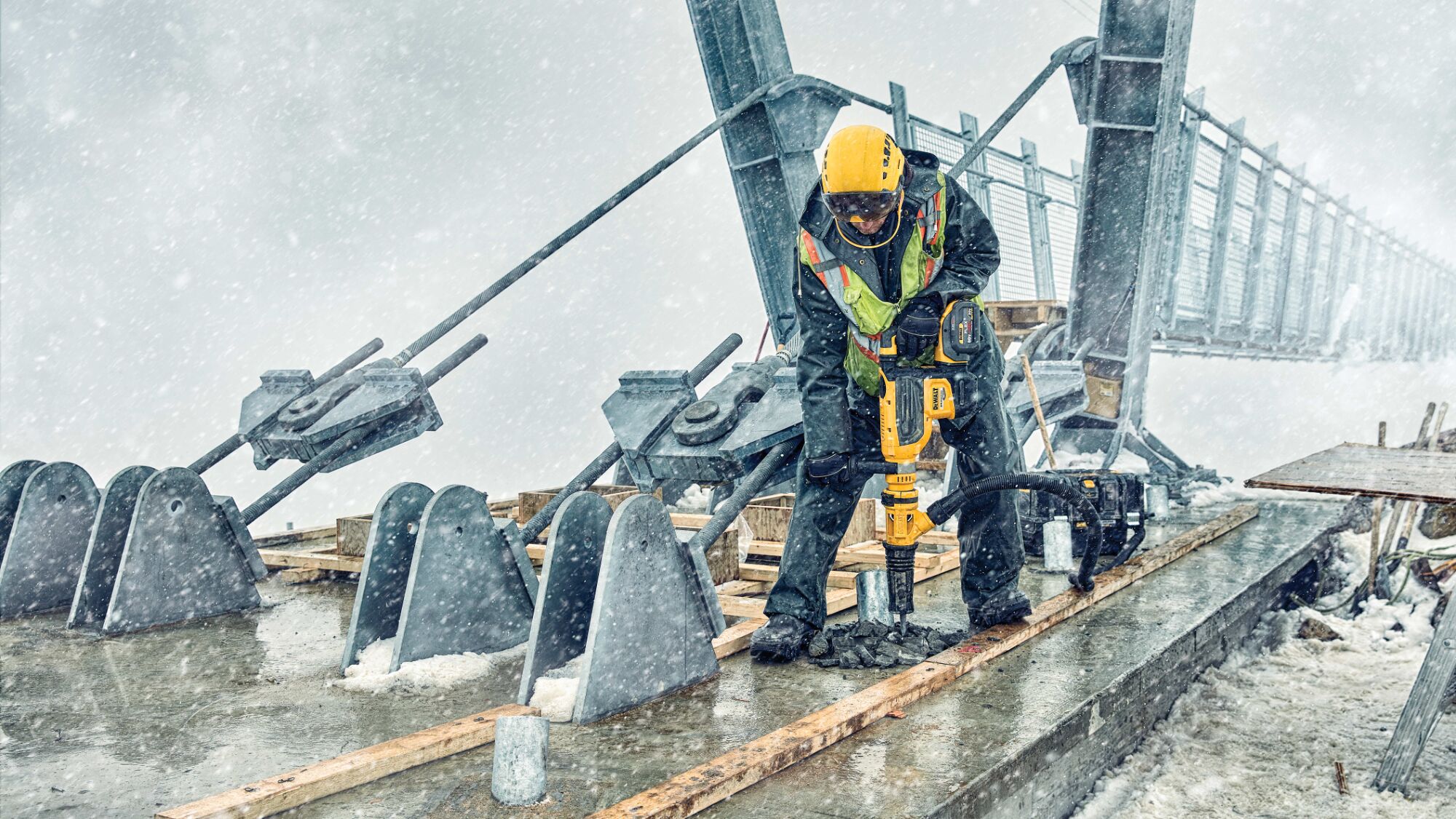 Brushless, cordless SDS MAX combination rotary hammer being used by a person in extreme conditions Brushless, cordless SDS MAX combination rotary hammer being used by a person in extreme conditions