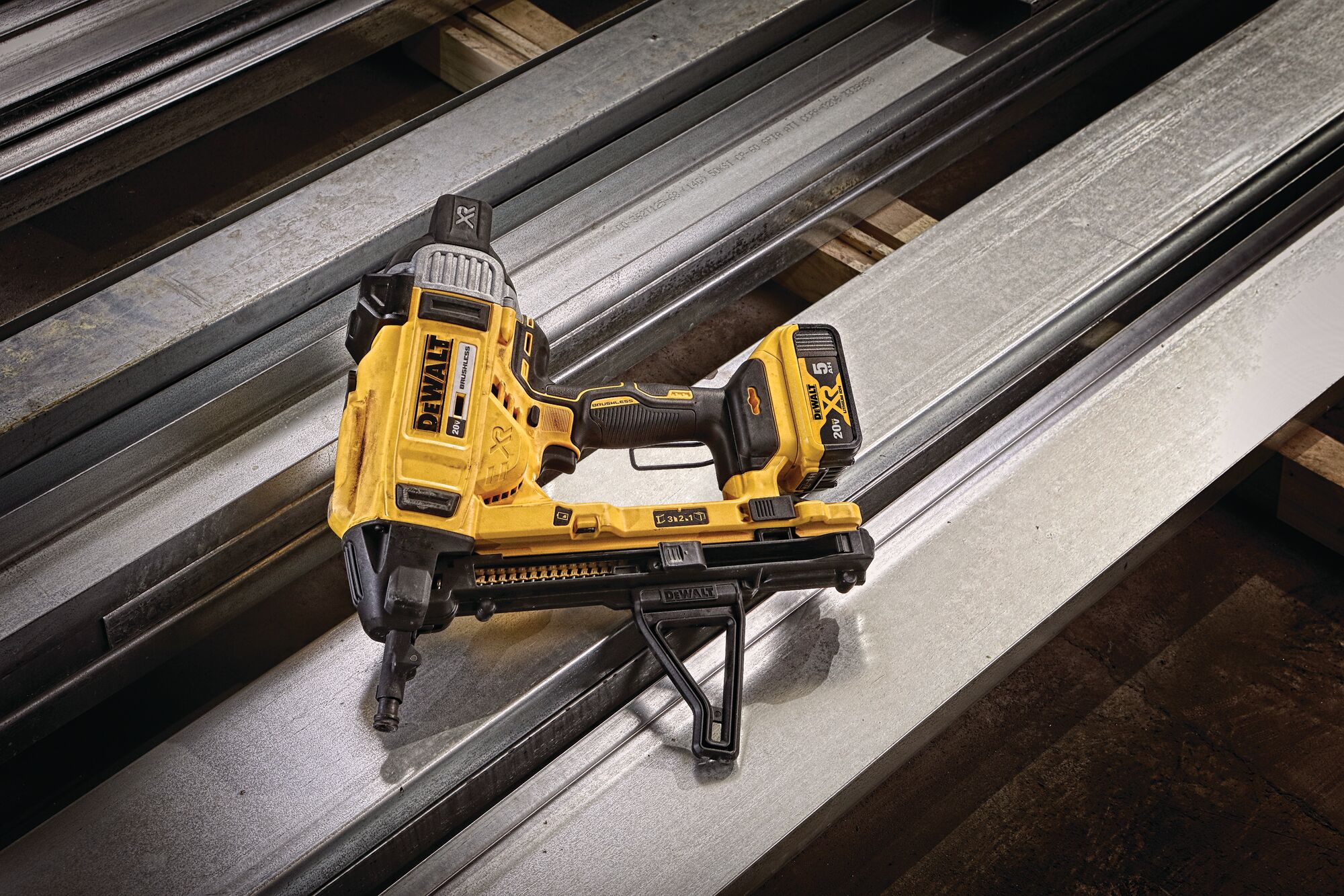 Magazine Cordless Concrete Nailer with a battery placed on drywall tracks. Magazine Cordless Concrete Nailer with a battery placed on drywall tracks.