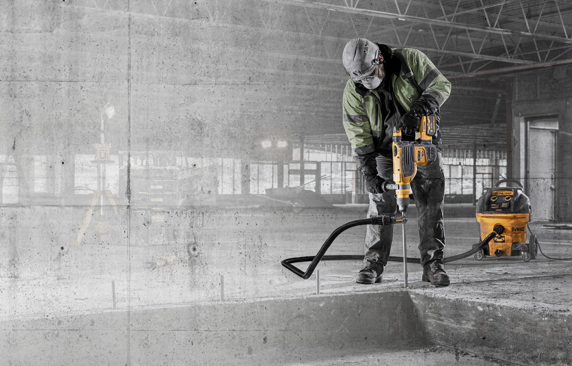 Construction worker with 60V MAX 1-7/8 In. Brushless Cordless SDS MAX Combination Rotary Hammer and dust extraction drilling into concrete with graphic concrete texture overlay Construction worker with 60V MAX 1-7/8 In. Brushless Cordless SDS MAX Combination Rotary Hammer and dust extraction drilling into concrete with graphic concrete texture overlay