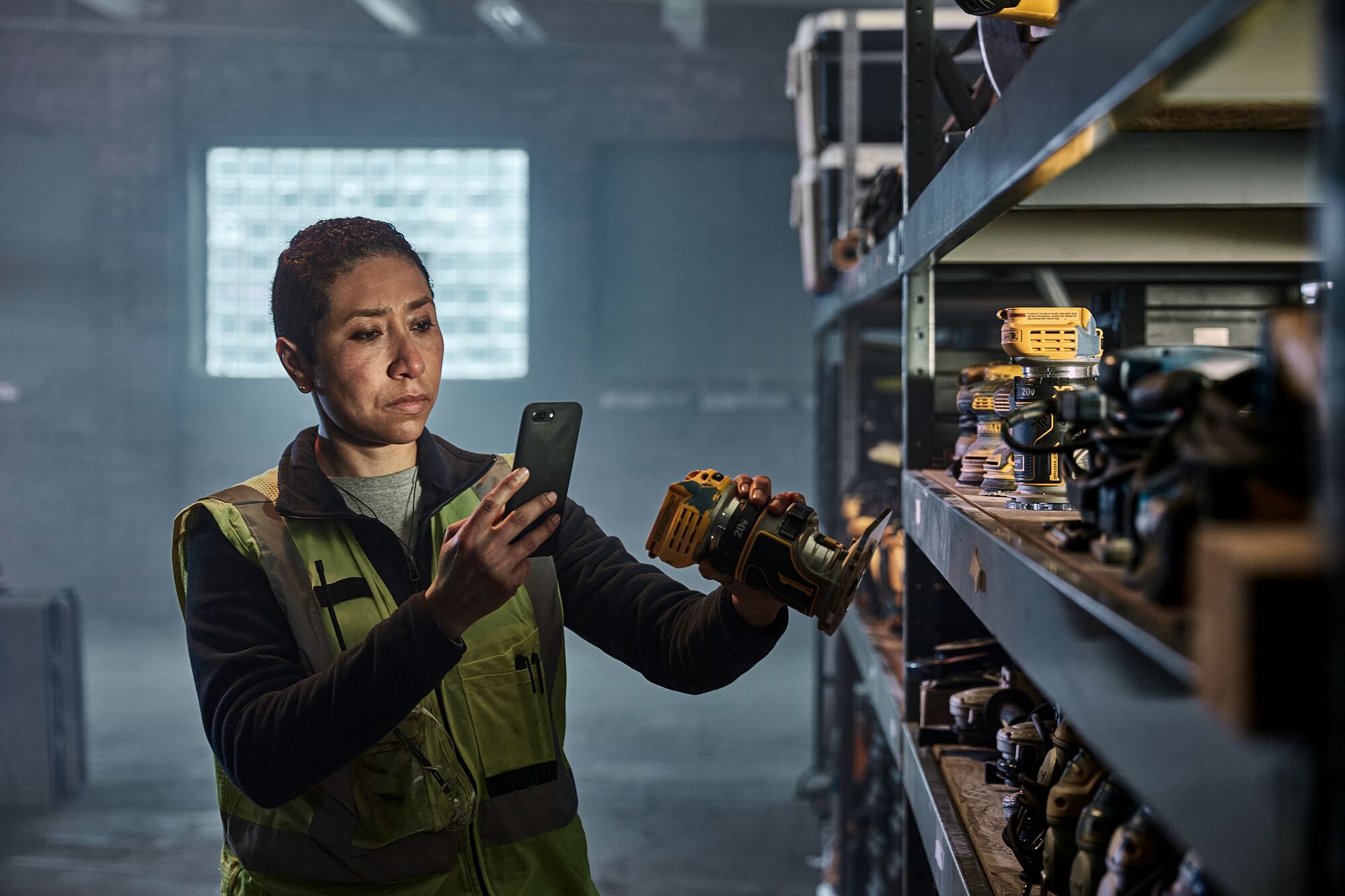 A woman is taking a picture of the DEWALT MATRIX™ Jig Saw Attachment for the Cordless Drill. A woman is taking a picture of the DEWALT MATRIX™ Jig Saw Attachment for the Cordless Drill.
