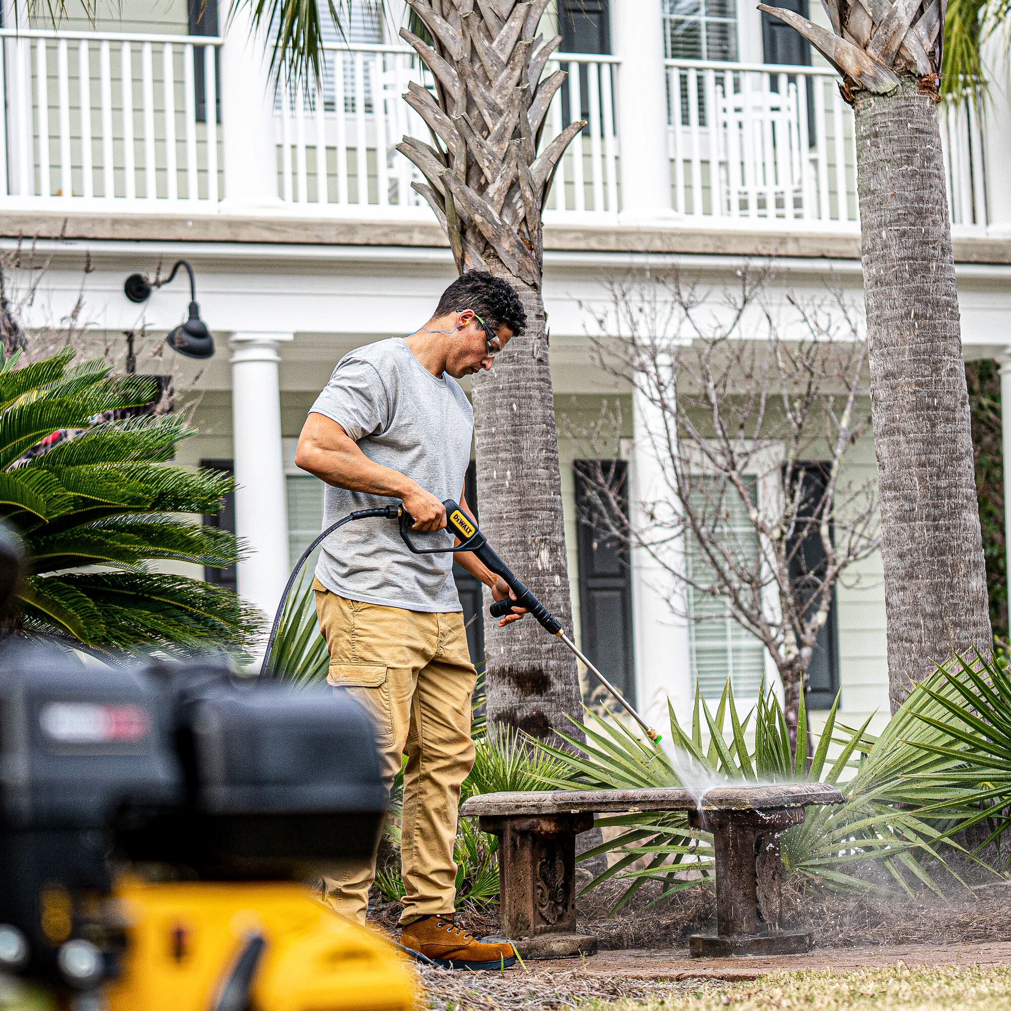 PressuReady 3400 PSI at 2.5 GPM Powered Cold Water Gas Pressure Washer being used by a person on a bench.