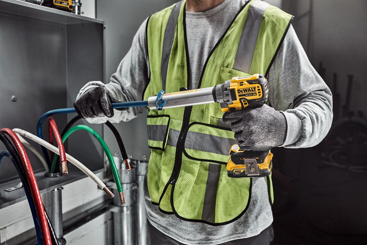 DEWALT Cable Stripper is used to strip a blue cable by a tradesman in an electrical room. DEWALT Cable Stripper is used to strip a blue cable by a tradesman in an electrical room.