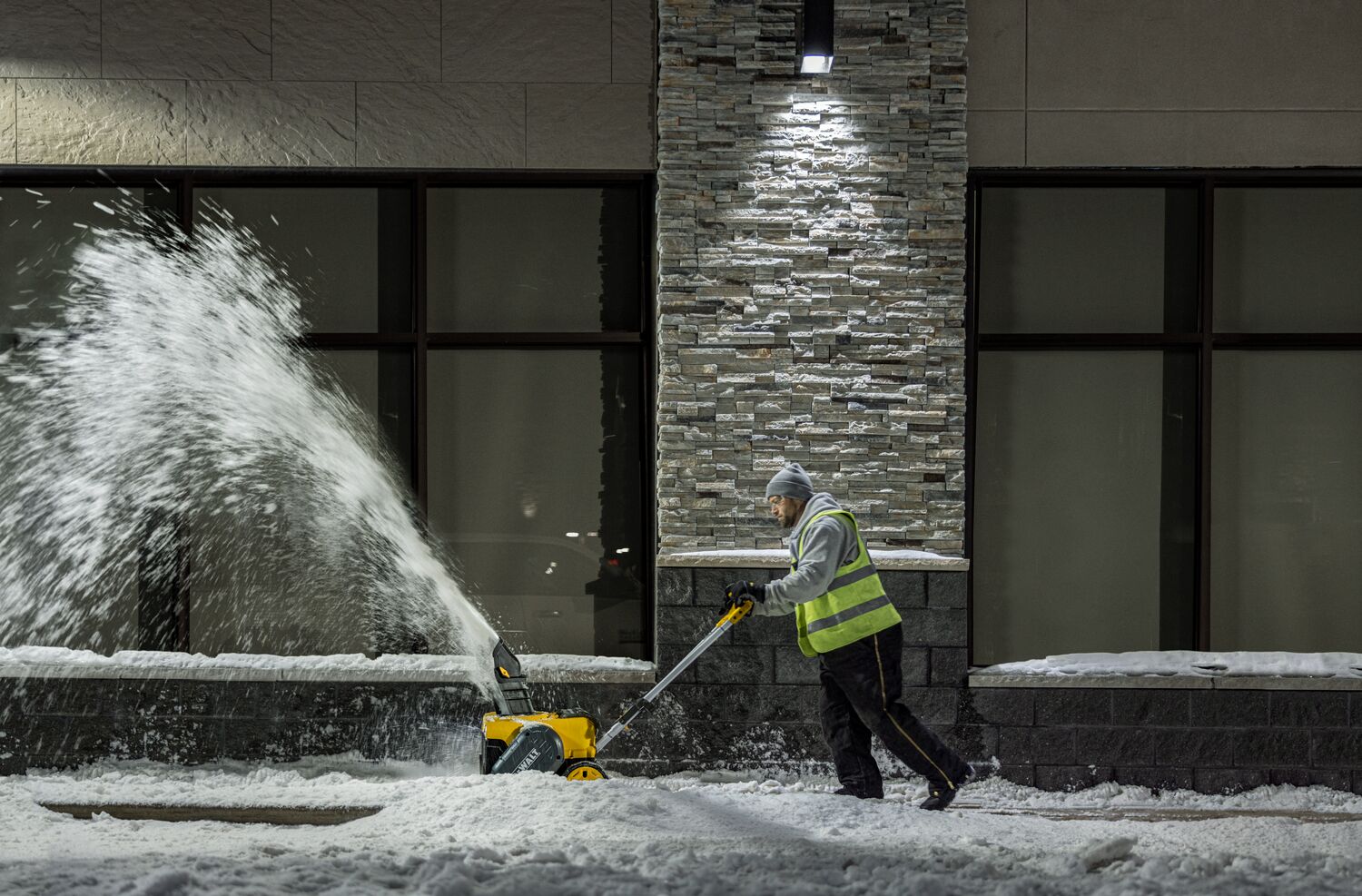 DEWALT Single-Stage Snow Blower application image person blowing snow side view DEWALT Single-Stage Snow Blower application image person blowing snow side view
