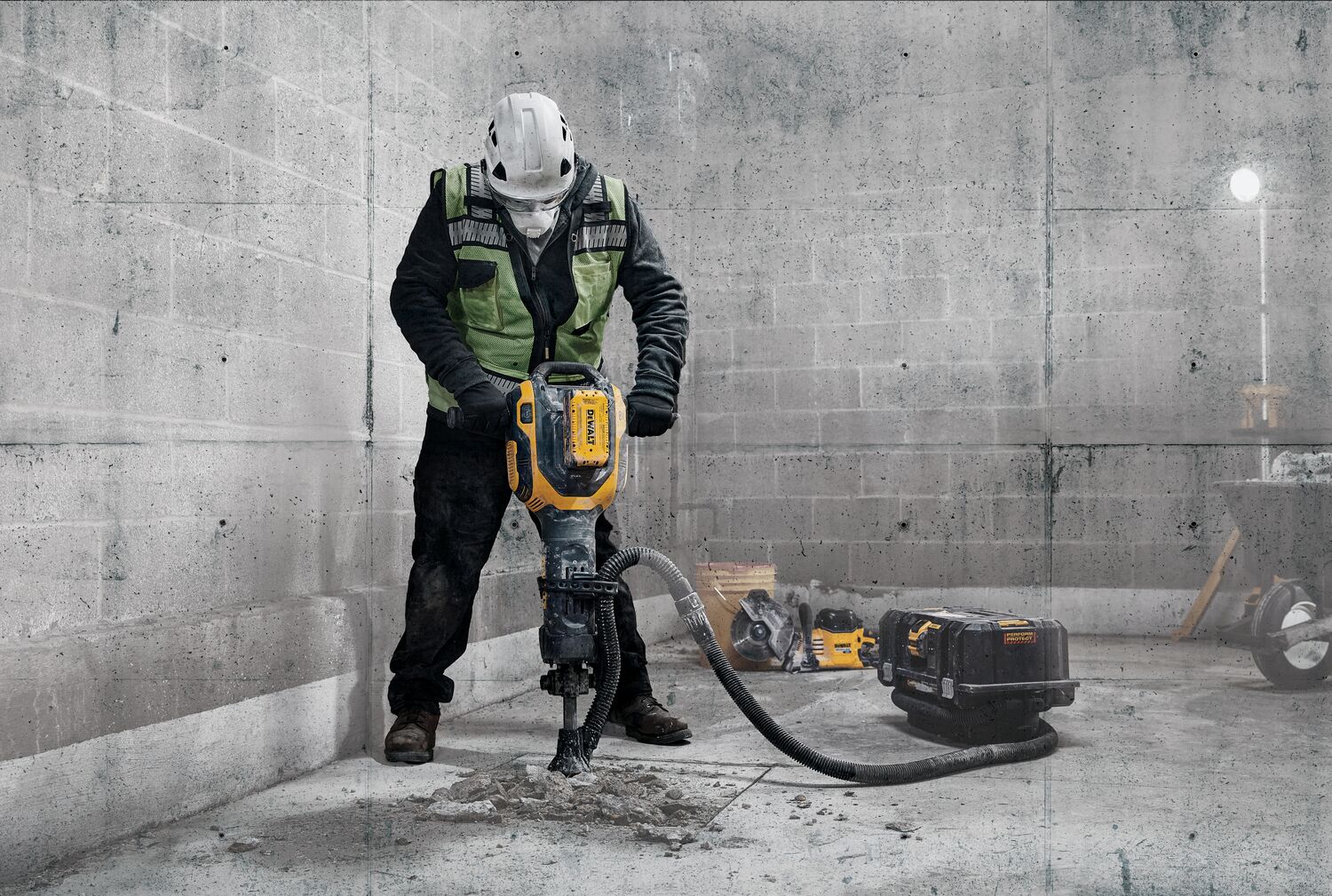 Man using 60 volt Max 38 pounds. 1-1/8 inch Hex Demolition hammer on concrete slab Man using 60 volt Max 38 pounds. 1-1/8 inch Hex Demolition hammer on concrete slab