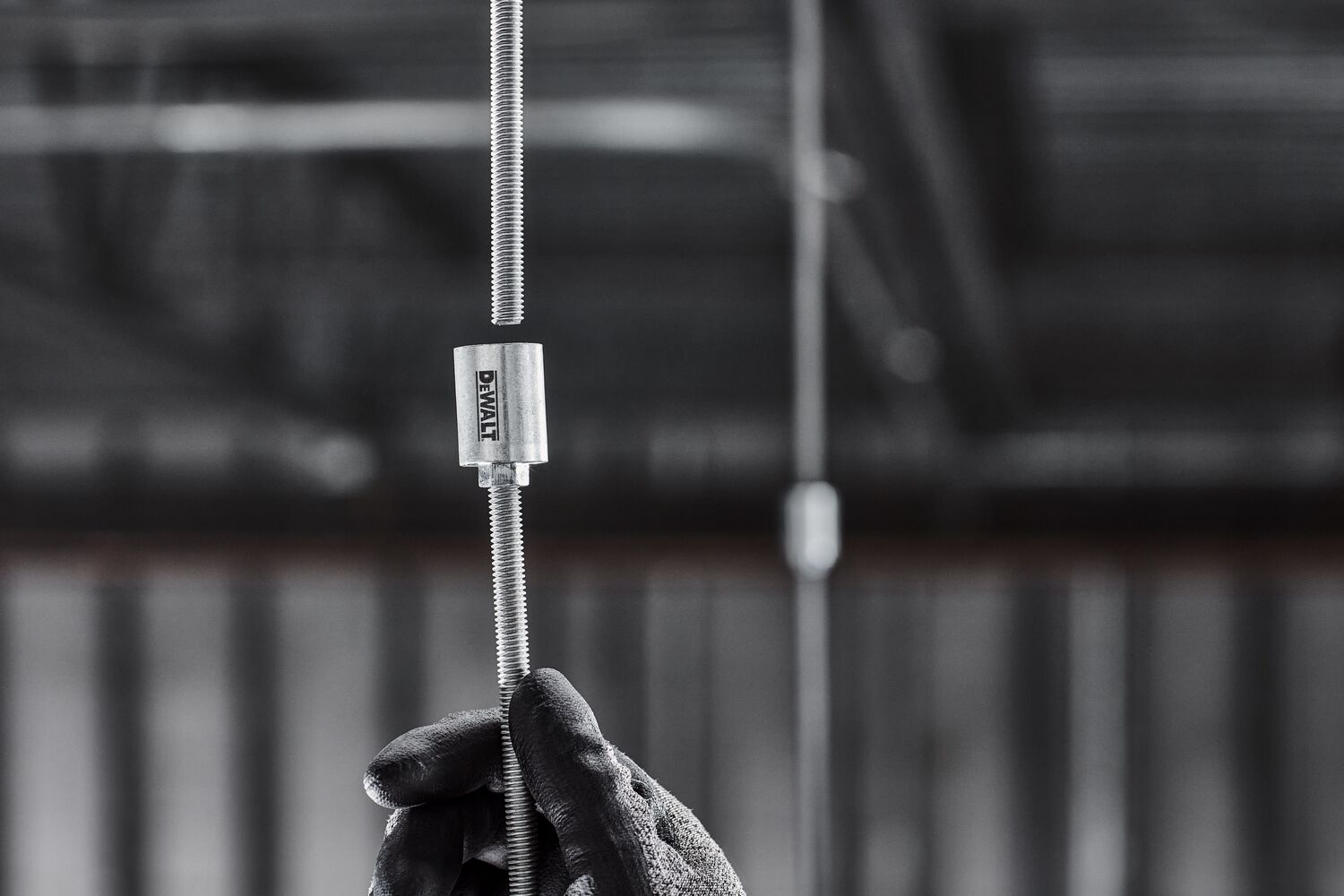 DEWALT PFM3613038 Coupler is attached to a hanging threaded rod in a mechanical room. DEWALT PFM3613038 Coupler is attached to a hanging threaded rod in a mechanical room.