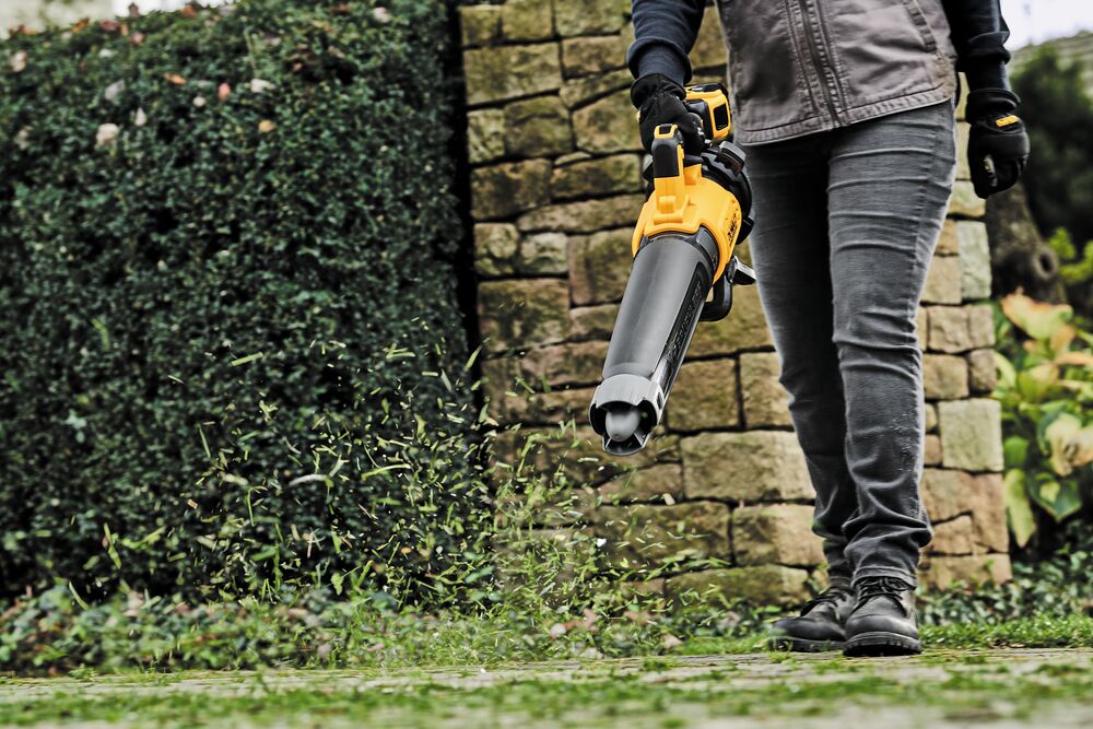 LITHIUM ION XR® Brushless, handheld blower with nozzle being used by a person to blow grass blades off ground. LITHIUM ION XR® Brushless, handheld blower with nozzle being used by a person to blow grass blades off ground.