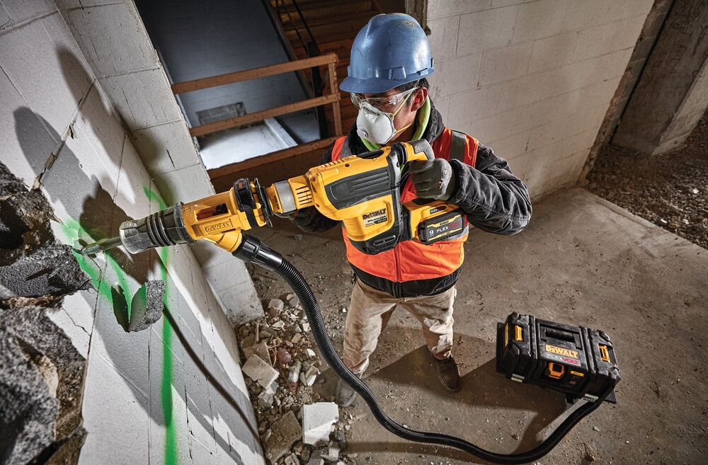 Brushless, cordless SDS MAX combination rotary hammer being used by a person Brushless, cordless SDS MAX combination rotary hammer being used by a person