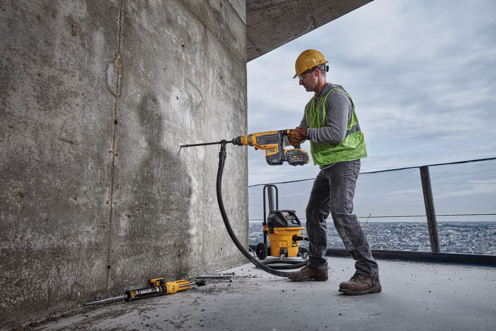 Brushless, cordless combination rotary hammer being used by a person Brushless, cordless combination rotary hammer being used by a person