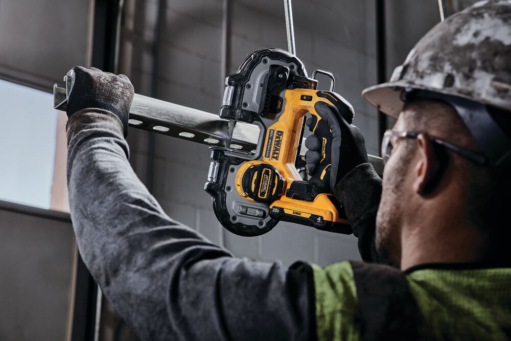 Brushless Cordless 1 and 3 quarters inch Compact Band Saw being used by worker to cut strut channel