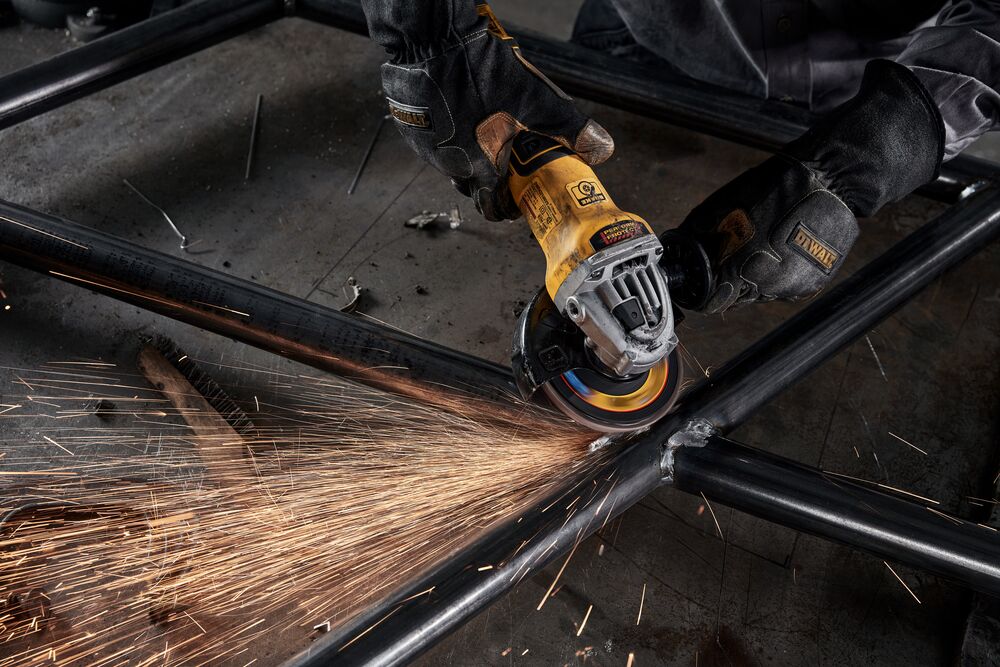 Person using DEWALT ELITE SERIES flap discs to clean up welds of pipes Person using DEWALT ELITE SERIES flap discs to clean up welds of pipes