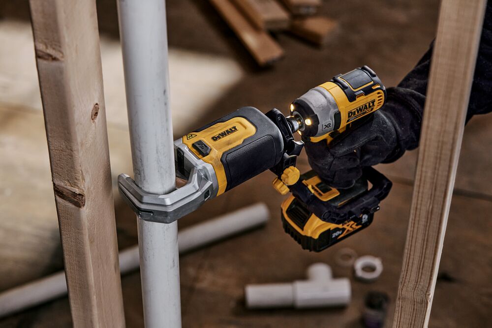 End user using DEWALT IMPACT CONNECT PVC/Pex Cutter attachment on Impact Driver to cut PVC pipe next to wood beam End user using DEWALT IMPACT CONNECT PVC/Pex Cutter attachment on Impact Driver to cut PVC pipe next to wood beam