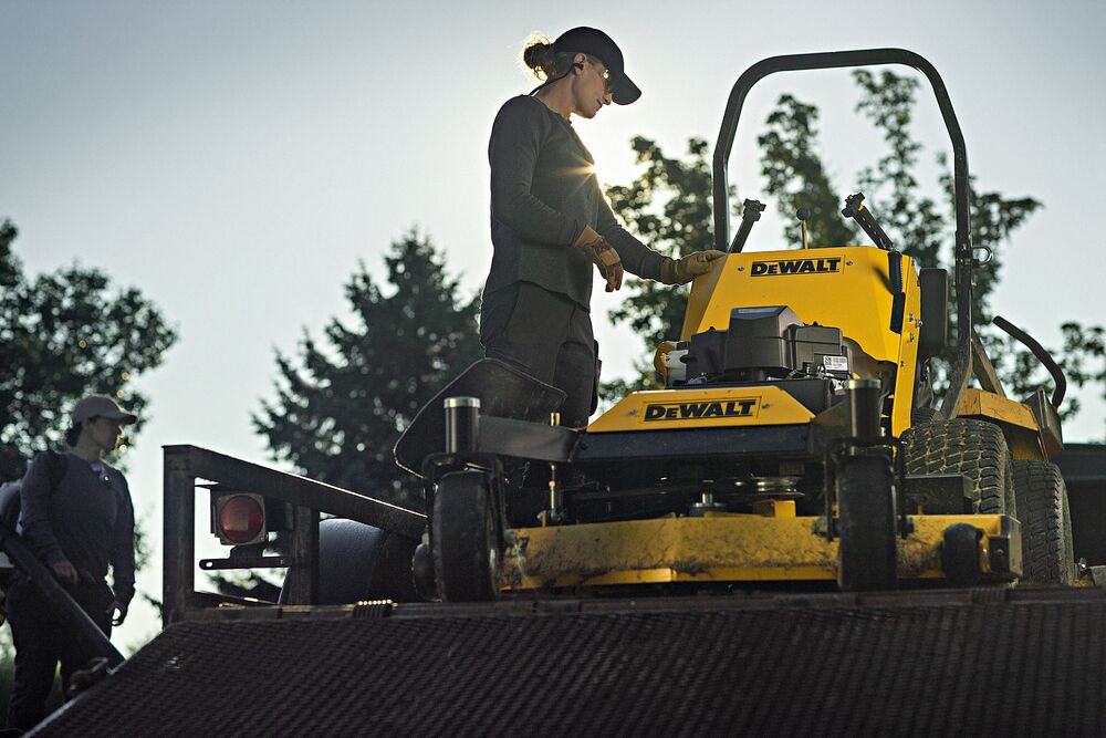48 inch Kawasaki Gas Hydrostatic Commercial Hydro Walk Mower being used by person to mow grass outdoors. 48 inch Kawasaki Gas Hydrostatic Commercial Hydro Walk Mower being used by person to mow grass outdoors.
