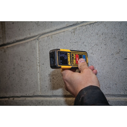Tool Connect 100 feet laser distance measurer in action.