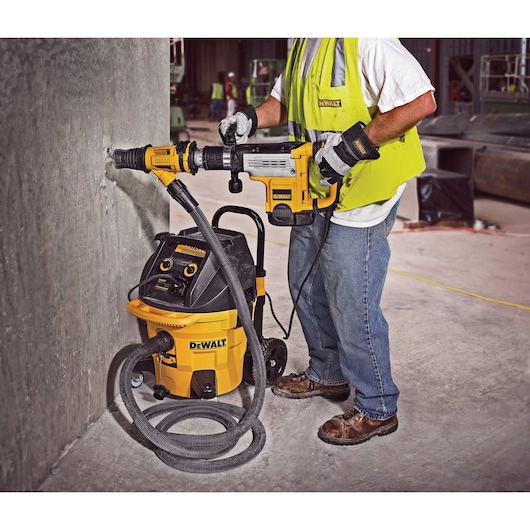 Close up of Large hammer dust extraction chiseling breaking pavement.