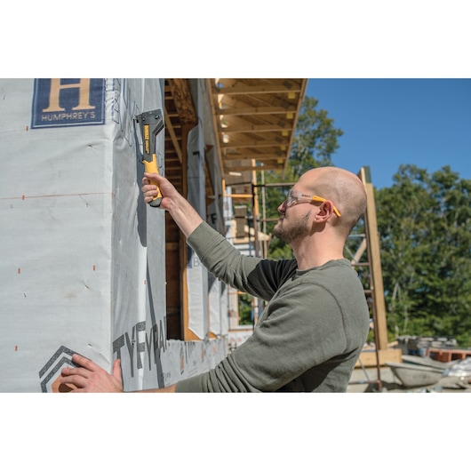 Carbon Fiber Composite Hammer Tacker being used on a construction site by a person.