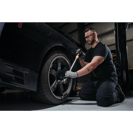 Drive torque wrench tire change kit being used to change tire.