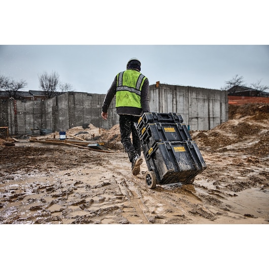 tough system 2.0 toolbox being taken to a different area of worksite by a worker.
