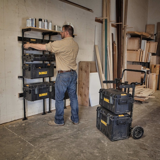tough system workshop racking system being fitted with a case from a carrier by a worker.