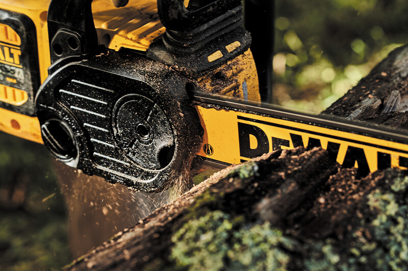 Close up of the cordless chainsaw sawing through a log. Close up of the cordless chainsaw sawing through a log.